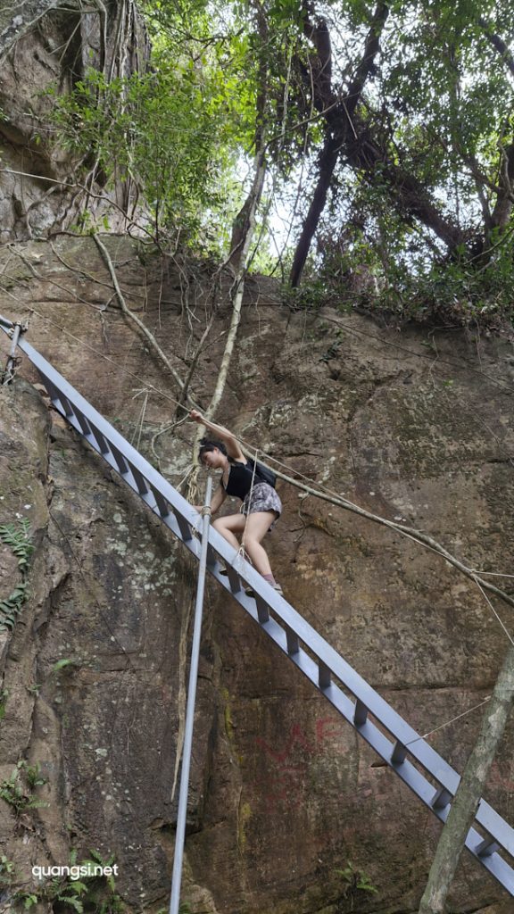 a woman climbing a ladder