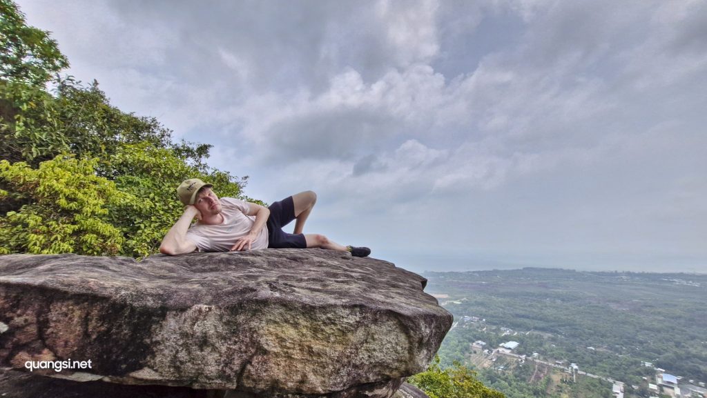 a man lying on a rock