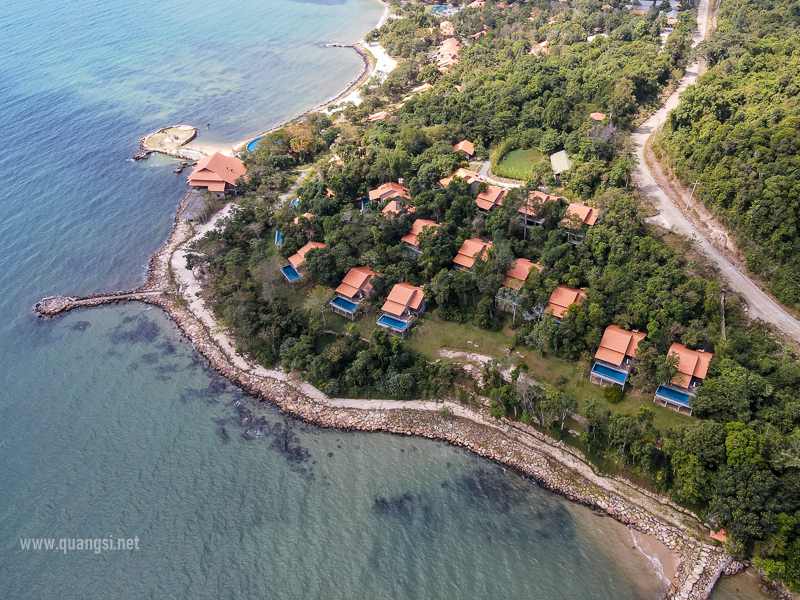 a aerial view of a beach with houses and trees