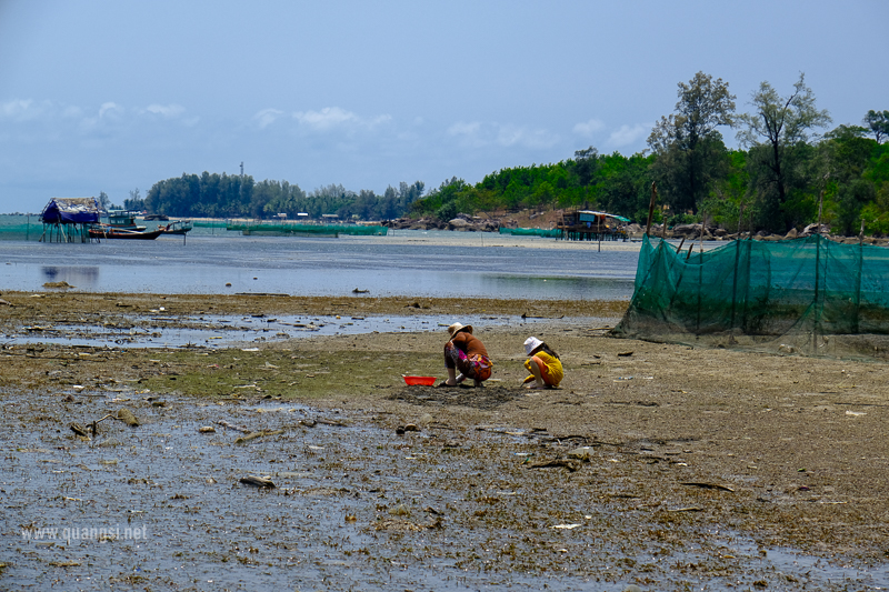 people on a beach with a net and a couple of people at Hon Mot